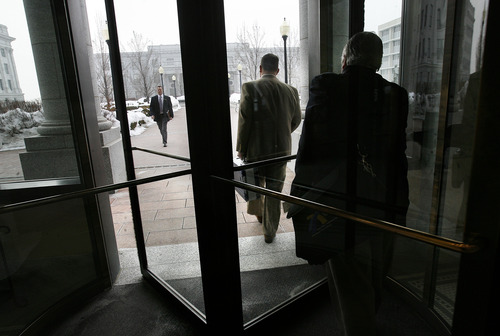 Scott Sommerdorf   |  The Salt Lake Tribune
Clark Aposhian, center, heads through the revolving doors in the Senate building on his way to the House building at the Utah State Capitol complex, Wednesday, February 6, 2013. Aposhian spends long days at the capitol every day during the legislative session advocating for gun rights.