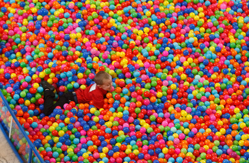 Trent Nelson  |  The Salt Lake Tribune
Davis Pauley plays in a pit of 18,532 plastic balls, one ball for every autistic child in Utah. Advocates for autism insurance reform placed the huge display in the Capitol Rotunda on Friday.