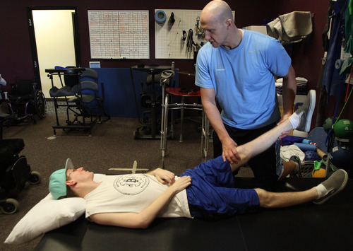 Rick Egan  | The Salt Lake Tribune 

Dale Lawrence, left, works on rehabilitation with Matt Hansen, right, at Neuroworx in South Jordan on Feb. 6, 2013. Lawrence was a wrestler at Wasatch High School in Heber when he was injured and paralyzed.