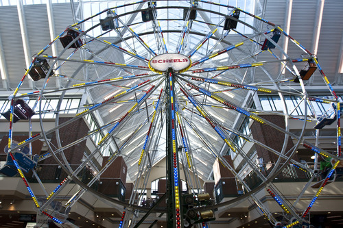 Chris Detrick  |  The Salt Lake Tribune
Couples plan to marry on the Ferris wheel at Scheels on Thursday. Scheels opened its 220,000-square-foot mega-sporting goods store in Sandy in September. The store features a 16-car Ferris wheel rising toward a skylight among other attractions.