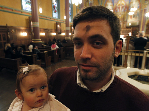 Al Hartmann  |  The Salt Lake Tribune
Clement Bataille attend Ash Wednesday observance at  the Cathedral of the Madeleine in Salt Lake City with his young daughter Zelie on Wednesday, Feb. 13.