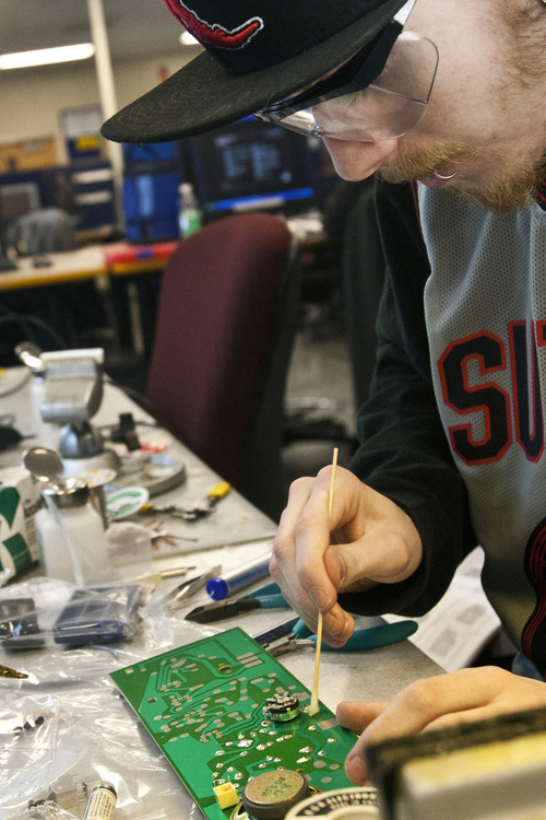 Chris Detrick  |  The Salt Lake Tribune
Chandler Thompson works at soldering an AM radio at Davis Applied Technology College in Kaysville. The Utah College of Applied Technology is bracing -- and seeking additinal funds -- for a growth spurt at its eight campuses.