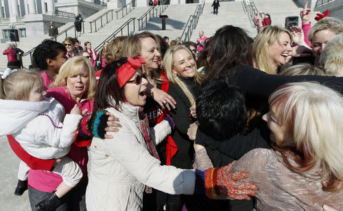 Al Hartmann  |  The Salt Lake Tribune
Women group-hug after doing their zumba dance routine on the south steps of the Utah State Capitol Thursday, Feb. 14, 2013, to raise awareness about violence against girls and women. Hundreds of dance demonstrations took place around the world for "One Billion Rising" a campaign on Valentine's Day to end violence against women and girls. It was sponsored by the YWCA and other nonprofits.