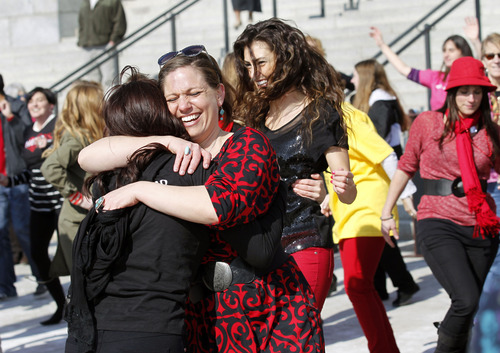Al Hartmann  |  The Salt Lake Tribune
Women hug after doing their zumba dance routine on the south steps of the Utah State Capitol Thursday February 14 to raise awareness about violence against girls and women. Hundreds of dance demonstrations took place around the world for "One Billion Rising" a campaign on Valentine's Day to end violence against women and girls. It was sponsored by the YWCA and other nonprofits.