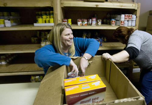 Kim Raff  |  The Salt Lake Tribune
Dana Stearn puts together a box of food for her and her family at Jesus Feeds Food Bank at The Church at Liberty Park in Salt Lake City on February 14, 2013. Utah generated a lot of jobs last year but still there is a growing need at area food banks.