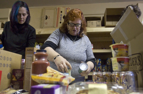 Kim Raff  |  The Salt Lake Tribune
(from left) Rhonie Lopez and Cheryl Law sort and shelve boxes of food at Jesus Feeds Food Bank at The Church at Liberty Park in Salt Lake City on February 14, 2013. Utah generated a lot of jobs last year but still there is a growing need at area food banks.