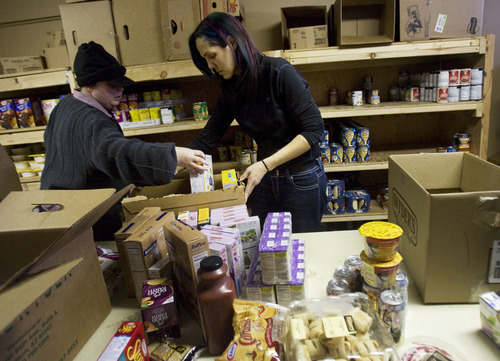 Kim Raff  |  The Salt Lake Tribune
(right) Rhonie Lopez helps (left) JD Kunz put together a box of food for herself at Jesus Feeds Food Bank at The Church at Liberty Park in Salt Lake City on February 14, 2013. Utah generated a lot of jobs last year but still there is a growing need at area food banks.