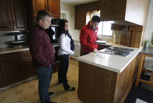 Rick Egan  | The Salt Lake Tribune 

Scott and Jami Holdaway tour a home in Salt Lake City with real estate agent, Mark Numbers, Wednesday, February 13, 2013.