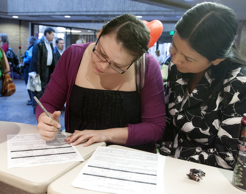 Steve Griffin  |  The Salt Lake Tribune
Partners Danielle Cruz and Roxana Colocho fill out an application for a license to marry at the Salt Lake County Government Center during the "Standing on the Side of Love" marriage equality rally in Salt Lake City on Thursday.