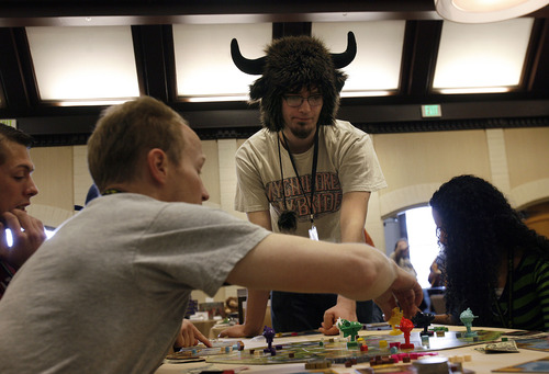 Scott Sommerdorf   |  The Salt Lake Tribune
Josh Anderson of Idaho Falls, Idaho, wearing a buffalo hat, watches the action while playing a game of "Kings of Air & Steam" at at SaltCON 2013, a board game convention at Sheraton Salt Lake City Hotel, Saturday, Feb. 15, 2013. The Ion Award Game Design Competition, for both unpublished and newly published designers, gives contestants a chance to show off their work to industry experts at SaltCON.