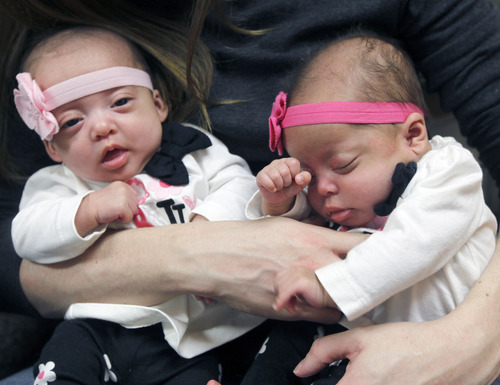 Al Hartmann  |  The Salt Lake Tribune
Sandy couple Charlie and Kelley Sandness have their hands full with quadruplets. The two girls are Mikayla, left, and Addison. Friends and family members pitch in to help with child care and meals.