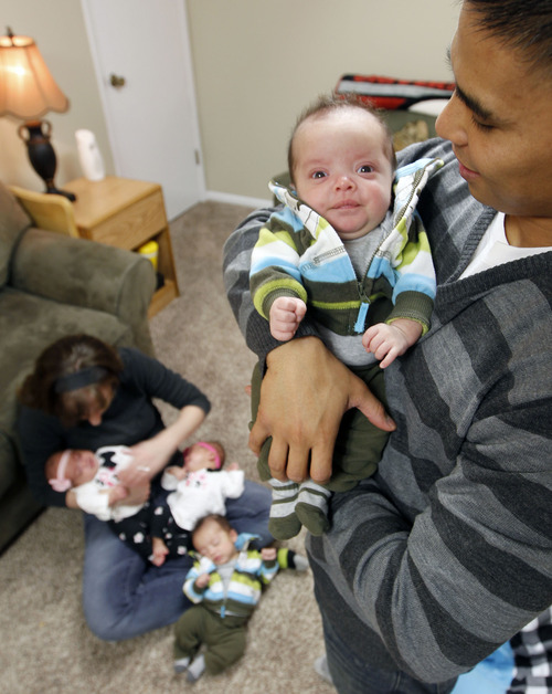 Al Hartmann  |  The Salt Lake Tribune
Charlie and Kelley Sandness have their hands full with  quadruplets. Charlie holdsAndrew while Kelley deals with Mason,  Mikayla and Addison.