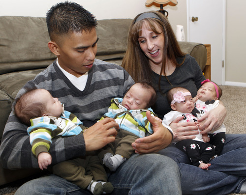 Al Hartmann  |  The Salt Lake Tribune
Charlie and Kelley Sandness have their hands full with  quadruplets. Charlie holds Andrew, left, and Mason. Kelley holds the girls, Mikayla, left, and Addison. The couple, who are both 29, say between feeding babies being every three hours -- which takes about 1 1/2 hours -- and diaper changes every six, "Team Sandness," as a doctor called them early on, requires its own army.