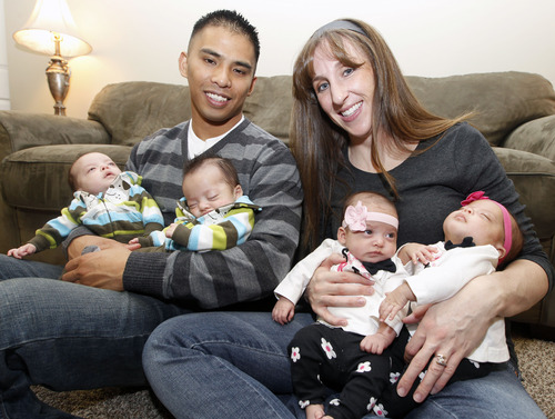 Al Hartmann  |  The Salt Lake Tribune
Charlie and Kelley Sandness, of Sandy, have their hands full with  quadruplets. Charlie holds Andrew, left, and Mason. Kelley holds the girls, Mikayla, left, and Addison.