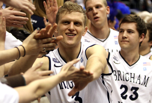 Rick Egan  | The Salt Lake Tribune 

Brigham Young Cougars guard Tyler Haws (3), Brigham Young Cougars guard Cory Calvert (23) shake hands with the fans after the BYU Cougars beat the Portland Pilots, at the Marriott Center, Saturday, February 16, 2013.