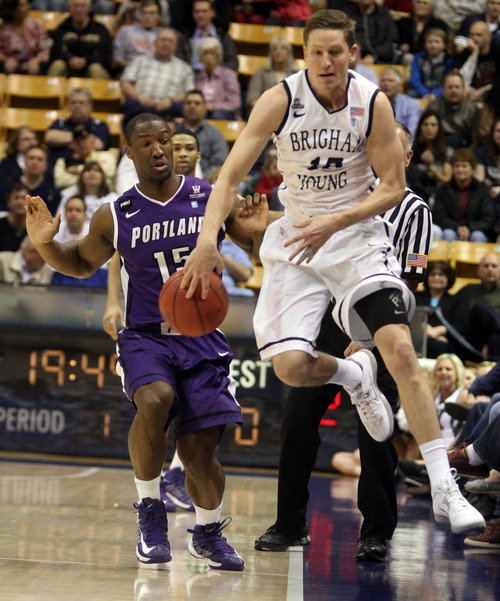 Rick Egan  | The Salt Lake Tribune 

Brigham Young Cougars guard Matt Carlino (10) saves the ball from going out of bounds,as Portland Pilots guard Derrick Rodgers (15) looks on,  in basketball action, as the BYU Coiugars played the Portland Pilots, at the Marriott Center, Saturday, February 16, 2013.