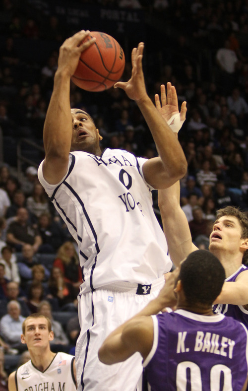 Rick Egan  | The Salt Lake Tribune 

Brigham Young Cougars forward Brandon Davies (0) grabs a lob pass, as he is double teamed by Portland's Kevin Bailey, in basketball action, as the BYU Cougars played the Portland Pilots, at the Marriott Center, Saturday, February 16, 2013.