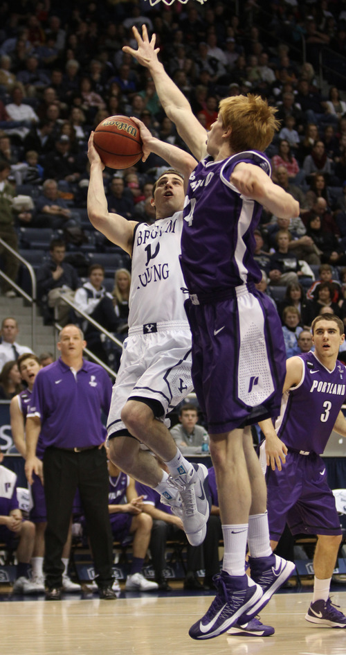 Rick Egan  | The Salt Lake Tribune 

Brigham Young Cougars guard Matt Carlino (10) takes a shot, as Portland Pilots center Riley Barker (14) defends, in basketball action, as the BYU Coiugars played the Portland Pilots, at the Marriott Center, Saturday, February 16, 2013.