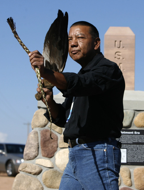 Rick Egan | The Salt Lake Tribune
Larry Cesspooch holds an eagle feather and a strand of sweet grass as he says  a prayer at the the dedication of a historical marker in 2009.  Cesspooch, a Ute, educates about what the symbols represent to Native Americans.