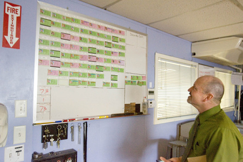 Paul Fraughton  |  The Salt Lake Tribune
Tim Hibler, director of the  Bonneville Community Correctional Center, looks over a board Friday showing the 73 inmates who are housed at the facility with one open space that will be filled within a few days.
