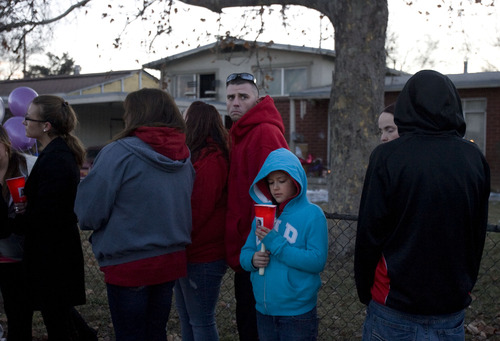Kim Raff  |  The Salt Lake Tribune
Alexia Franco, center, a niece of Danielle Lucero, stands with family and friends during a candlelight vigil Sunday at the Midvale home where Lucero, Omar Jarman and Shontay Young were shot to death.
