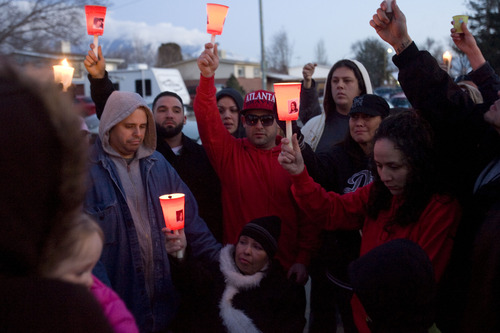 Kim Raff  |  The Salt Lake Tribune
Friends and family of Danielle Lucero, including Lucero's brother Andrew Lucero, center, and her mother, Teresa Espinosa, seated, gather for a candlelight vigil Sunday at the Midvale home where Lucero, Omar Jarman and Shontay Young were slain.