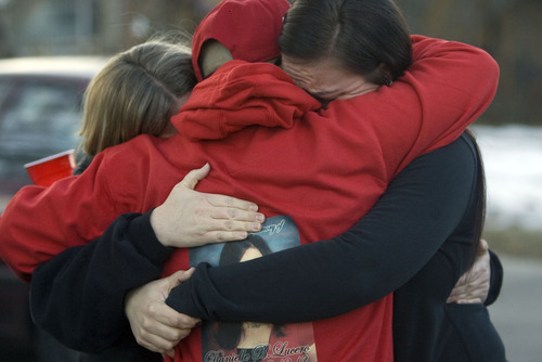 Kim Raff  |  The Salt Lake Tribune
Mary Beltran, left, and her daughter Lachele Beltran, who are neighbors of Danielle Lucero, comfort Lucero's brother, Andrew Lucero, center, who is wearing a sweatshirt with his sister's picture on it, during a candlelight vigil Sunday at the Midvale home where Lucero, Omar Jarman and Shontay Young were slain.