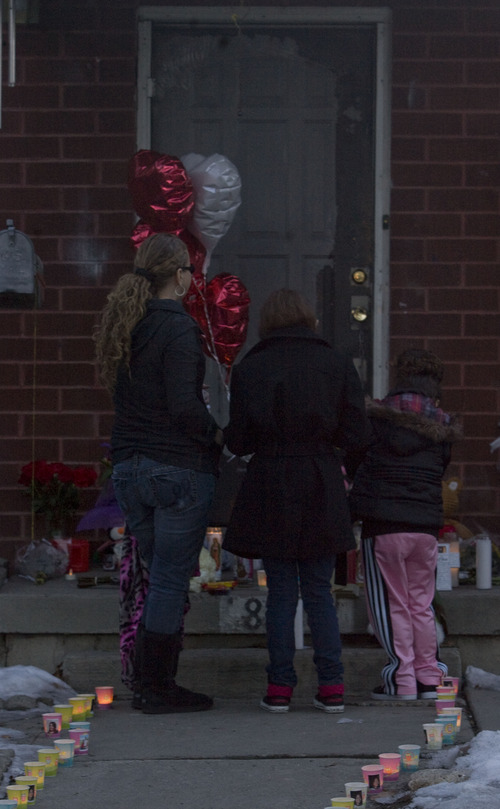 Kim Raff  |  The Salt Lake Tribune
Friends and family of Danielle Lucero gather Sunday near memorial on the steps of Midvale home where Lucero, Omar Jarman and Shontay Young were slain.