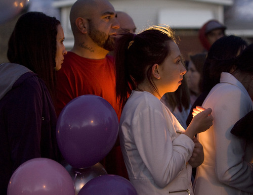 Kim Raff  |  The Salt Lake Tribune
McKinzi Atwood, a friend of Danielle Lucero, attends a candlelight Sunday at the Midvale home where Lucero, Omar Jarman and Shontay Young were slain.