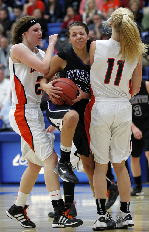 Al Hartmann  |  The Salt Lake Tribune
Riverton High School's Shelby Richards finds no room to move between  Brighton High School's Lindsey Johnson, left, and Alyssa Hirschi at the 5A girls' playoff game at Salt Lake Community College Monday February 18.