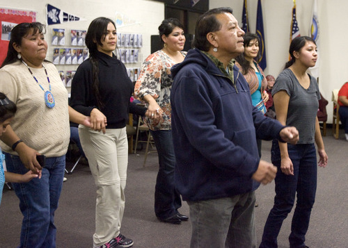 Kim Raff  |  The Salt Lake Tribune
Larry Cesspooch dances as drummers perform and sing during a Round Dance, organized by members of the Ute Indian Tribe, at Uinta River High School in Fort Duchesne on Feb. 9, 2013.