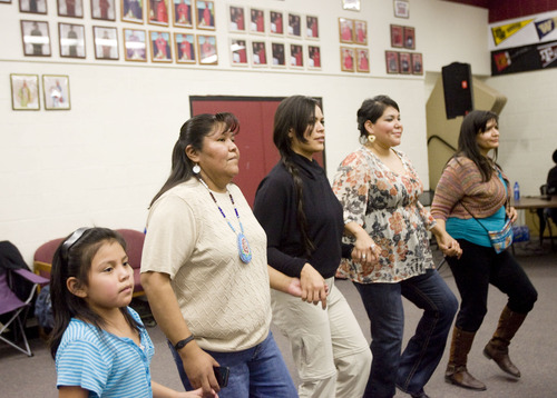 Kim Raff  |  The Salt Lake Tribune
People dance as drummers perform and sing during a Round Dance, organized by members of the Ute Indian Tribe, at Uinta River High School in Fort Duchesne on Feb. 9, 2013.
