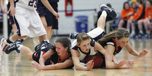 Al Hartmann  |  The Salt Lake Tribune
Mtn. Crest High School's Kiera Knight, left, Springville High School's Kate Hullinger, and Mtn. Crest's Kelsee Nelson, hit the floor after chasing down a loose ball together battling for control during a Girl's 4A play off game at Salt Lake Community College Tuesday, February 19.