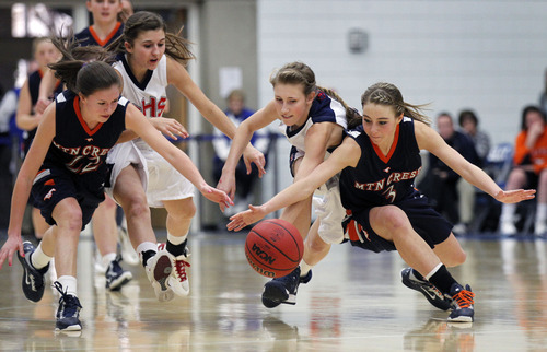 Al Hartmann  |  The Salt Lake Tribune
Mtn. Crest High School's Kiera Knight, left, Springville High School's Baylee Park and Kate Hullinger, and Mtn. Crest's Kelsee Nelson, chase down a loose ball together battling for control during a Girl's 4A play off game at Salt Lake Community College Tuesday, February 19.