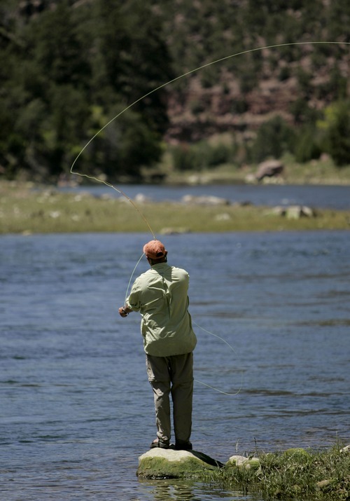 Ed Duffey of Ft. Carson, Colorado, fishes alone for a moment during lunch on the Green River outside of Dutch John, Utah, Saturday, June 21, 2008 as part of Rivers of Recovery program. Ed Duffey served with the Army and during the initial invasion of Iraq in 2003 he was blown off a vehicle by a mortar round which resulted in limited shoulder mobility. Rivers of Recovery is a nonprofit organization that specializes in taking disabled veterans on fly-fishing trips on the Green River in hopes of helping the veterans in their recovery. 06/21/2008 Jim Urquhart/The Salt Lake Tribune