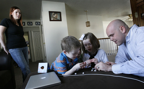Scott Sommerdorf   |  The Salt Lake Tribune
Kylee Duff, left, watches two of her children, Jonah, 5, and Mikelle, 7, play with her husband, Matt, before Matt takes them to church, Sunday, Feb. 3, 2013. Kylee is staying home to tend to a newborn. The Duffs were married in the Salt Lake LDS Temple and living happy, Mormon lives until about this time last year, when Matt began to question his faith.