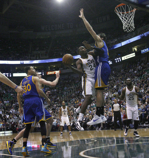Chris Detrick  |  The Salt Lake Tribune
Utah Jazz power forward Paul Millsap (24) shoots past Golden State Warriors center Andrew Bogut (12) during the first half of the game at EnergySolutions Arena Tuesday February 19, 2013. The Jazz are winning the game 58-53.