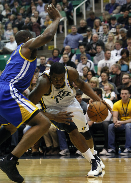 Chris Detrick  |  The Salt Lake Tribune
Utah Jazz power forward Derrick Favors (15) runs past Golden State Warriors power forward Carl Landry (7) during the first half of the game at EnergySolutions Arena Tuesday February 19, 2013. The Jazz are winning the game 58-53.
