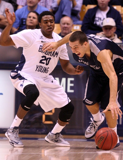 Leah Hogsten  |  The Salt Lake Tribune
Brigham Young Cougars guard Anson Winder (20) battles Utah State Aggies guard/forward Spencer Butterfield (21)for possession. Brigham Young University Cougars defeated Utah State University Aggies 70-68 in Provo, February 19, 2013.