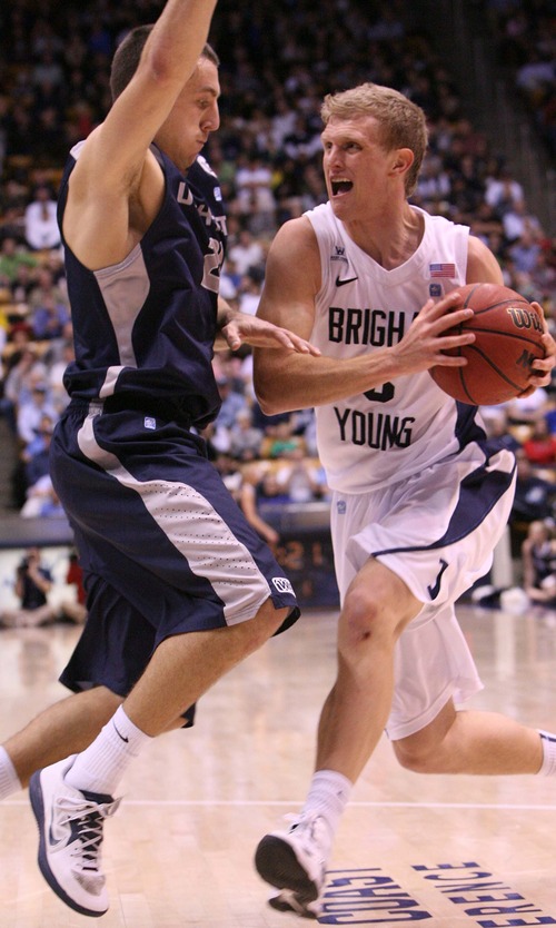 Leah Hogsten  |  The Salt Lake Tribune
Brigham Young Cougars guard Tyler Haws (3) battles Utah State Aggies guard/forward Spencer Butterfield (21)to the net. Brigham Young University Cougars defeated Utah State University Aggies 70-68 in Provo, February 19, 2013.