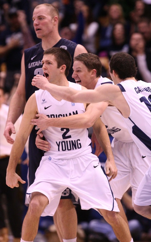 Leah Hogsten  |  The Salt Lake Tribune
Brigham Young Cougars guard Brock Zylstra (13) and Brigham Young Cougars guard Matt Carlino (10) celebrates the win with teammate Brigham Young Cougars guard Craig Cusick (2) after he sunk the rebound off the rim to win the game in the remaining moments. Brigham Young University Cougars defeated Utah State University Aggies 70-68 in Provo, February 19, 2013.