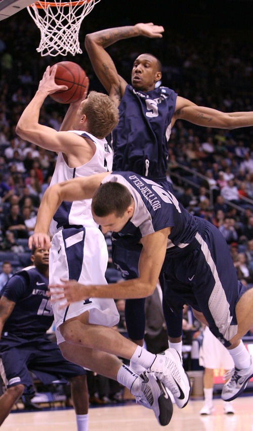 Leah Hogsten  |  The Salt Lake Tribune
Brigham Young Cougars guard Tyler Haws (3) drives the net between Utah State Aggies guard/forward Spencer Butterfield (21) and Utah State Aggies center Jarred Shaw (5). Brigham Young University Cougars defeated Utah State University Aggies 70-68 in Provo, February 19, 2013.