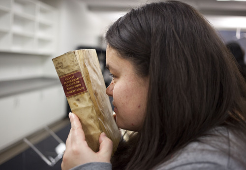 Lennie Mahler  |  The Salt Lake Tribune
Tera Peay smells a first edition of "Christophori Clavii Bambergensis e Societate Iesv: Astrolabivm. Cvm privilegio" by Christoph Clavius in the special collections area of the Marriott Library.
