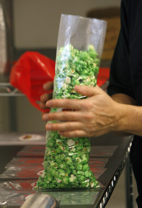 Francisco Kjolseth  |  The Salt Lake Tribune
When it comes to gourmet popcorn, things have come a long way as Scott Roose fills a bag with green apple popcorn at Rooster's Popcorn in South Jordan. Flavor options go beyond the usual caramel and cheese as he and his wife Holly offer 60 different flavors both savory and sweet including: loaded baked potato dill pickle, Paremsan garlic, Oreo cookie, white chocolate pretzel, cake batter, cinnamon toast and even soda flavors such as Mountain Dew, Dr. Pepper and Root Beer.