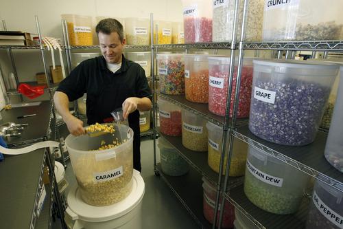 Francisco Kjolseth  |  The Salt Lake Tribune
Scott Roose is surrounded by popcorn of all colors and flavors as he fills an order for a customer recently at Rooster's Popcorn in South Jordan, where he is co-owner with his wife Holly. On the menu are 60 different flavors both savory and sweet including: loaded baked potato dill pickle, Paremsan garlic, Oreo cookie, white chocolate pretzel, cake batter, cinnamon toast and even soda flavors such as Mountain Dew, Dr. Pepper and Root Beer.