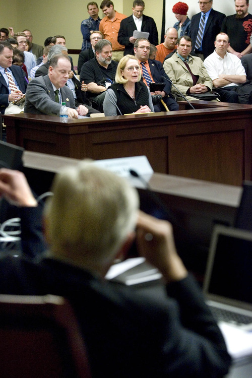 Paul Fraughton  |  The Salt Lake Tribune
As Sandy Krueger speaks against Rep. Brian Greene's HB114, which would allow local sheriffs to arrest federal agents trying to seize guns from Utah residents, people in favor of the bill stand in line to voice their support.  Friday, February 22, 2013