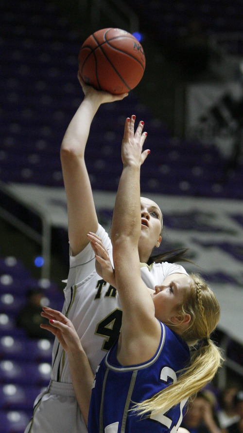 Rick Egan  | The Salt Lake Tribune 

Dixie's Liz Empy (21) defends as Desert Hill's Kassidy Cox takes a shot, in the 3A girls state championship game, Dixie vs. Desert Hills,  in Ogden, Saturday, February 23, 2013