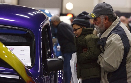 Leah Hogsten  |  The Salt Lake Tribune
Joe Maestas of Sandy lifts his grandson Ayden, 6, so he can peek into 1946 Ford Sedan. Over 300 custom cars, classics, hot rods, trucks, motorcycles and race cars are on display at The 39th Annual Parts Plus Autorama at the South Towne Expo Center, February 23, 2013. The show ends Sunday, February 24, 2013
