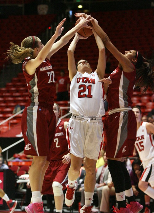 Kim Raff  |  The Salt Lake Tribune
University of Utah player (middle) Chelsea Bridgewater tries to shoot the ball as Washington State players (left) Sage Romberg and (right) Shalie Dheensaw defend during a game at the Huntsman Center in Salt Lake City on February 24, 2013. Utah went on to win 59-47.
