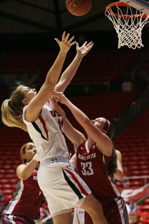 Kim Raff  |  The Salt Lake Tribune
University of Utah player (left) Taryn Wicijowski shoots the ball as Washington State players (right) Carly Noyes defends during a game at the Huntsman Center in Salt Lake City on February 24, 2013. Utah went on to win 59-47.